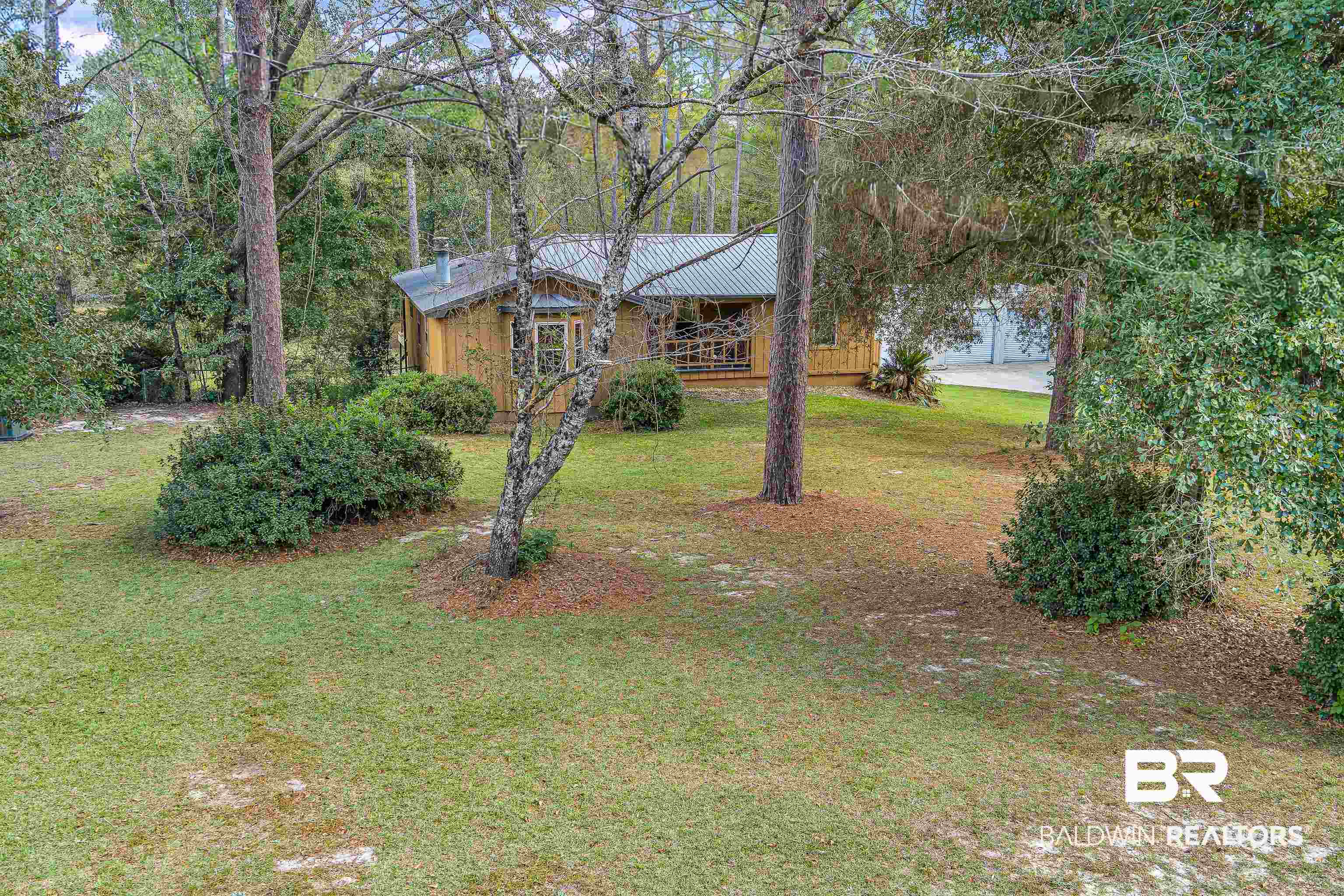 22970 River Road South Daphne, AL 36526 - Photo 21 of 48 View of front of house with a front yard and a metal roof