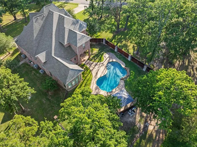 an aerial view of a house with a yard and garden