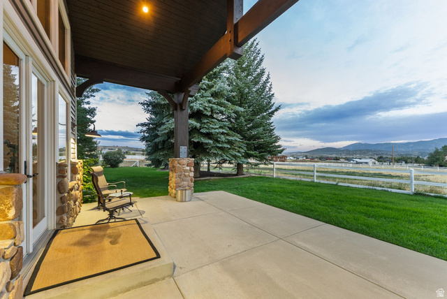 8650 Redden Road Park City, UT 84098 - Photo 44 of 71 Covered patio with stone pillars and exposed wood beams