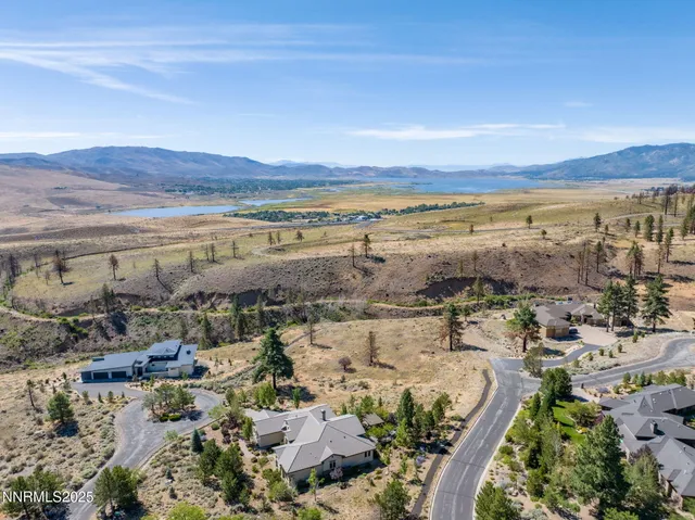a view of a dry yard with wooden fence