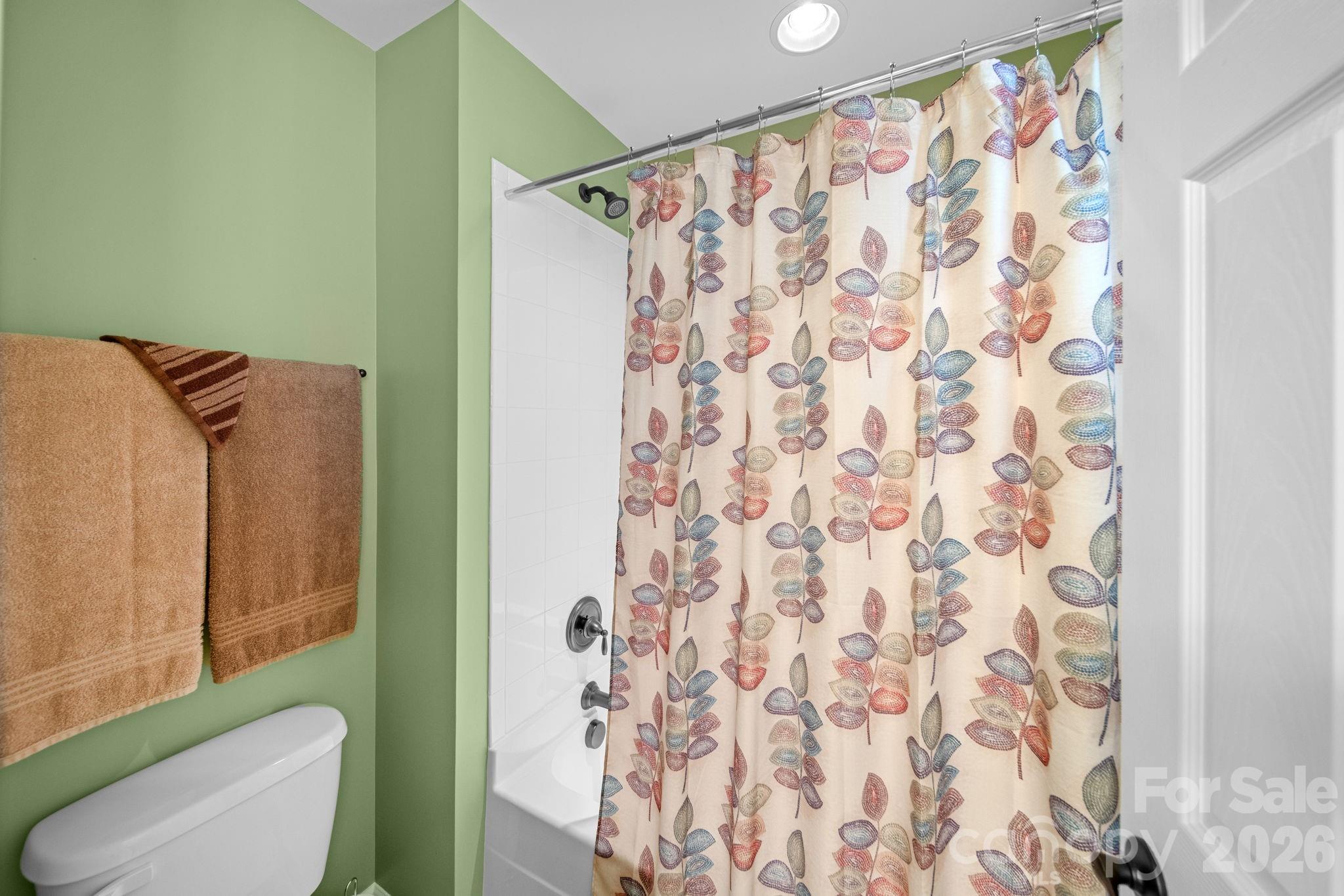 115 Inlet Point Drive Fort Mill, SC 29708 - Photo 27 of 48 a bathroom with a shower curtain and a toilet