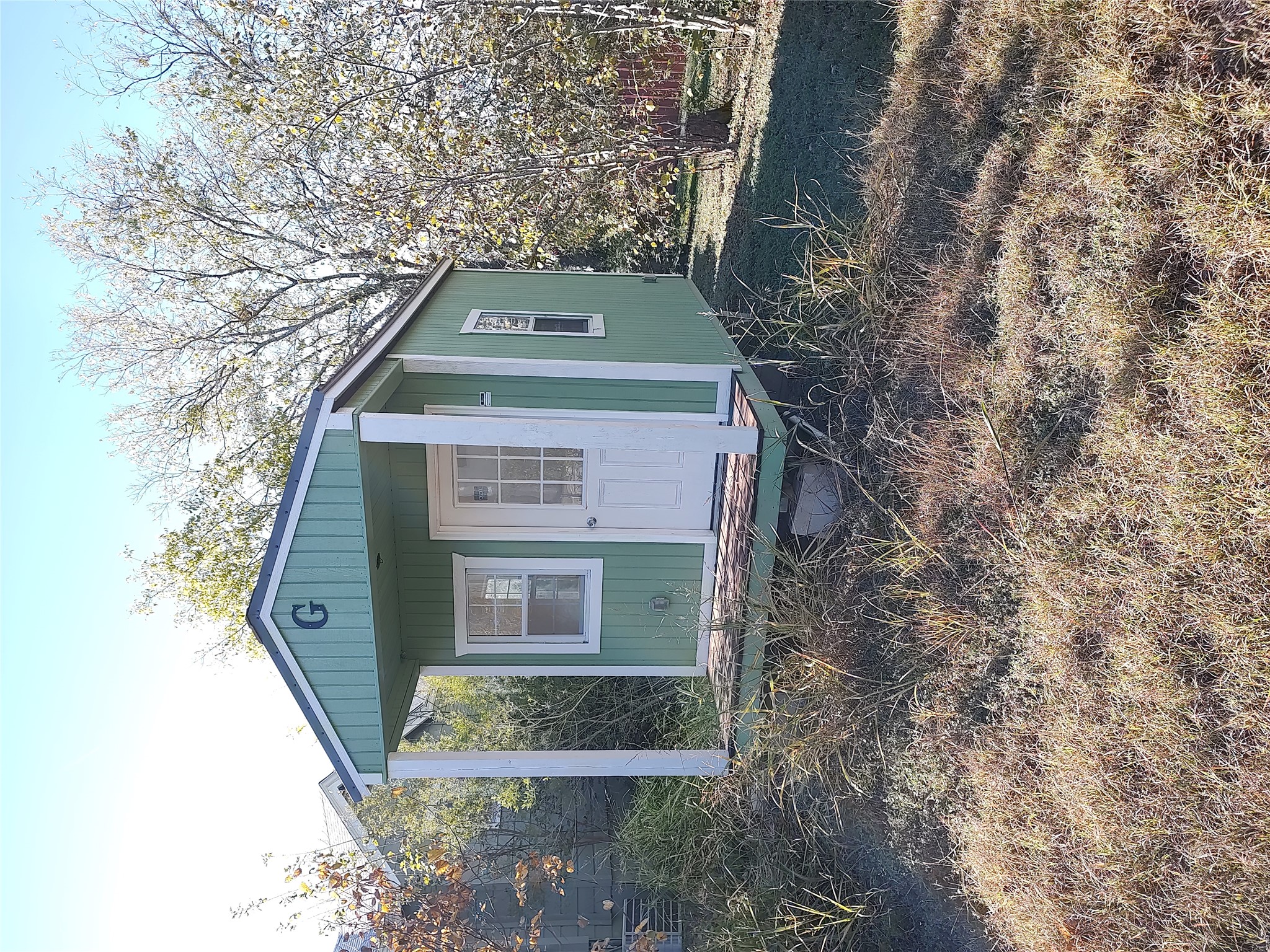 2102 Yellow Jacket Lane, Unit A Austin, TX 78741 - Photo 14 of 15 a front view of a house with a yard and garage