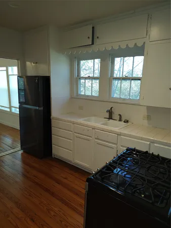 a kitchen with a refrigerator and a stove