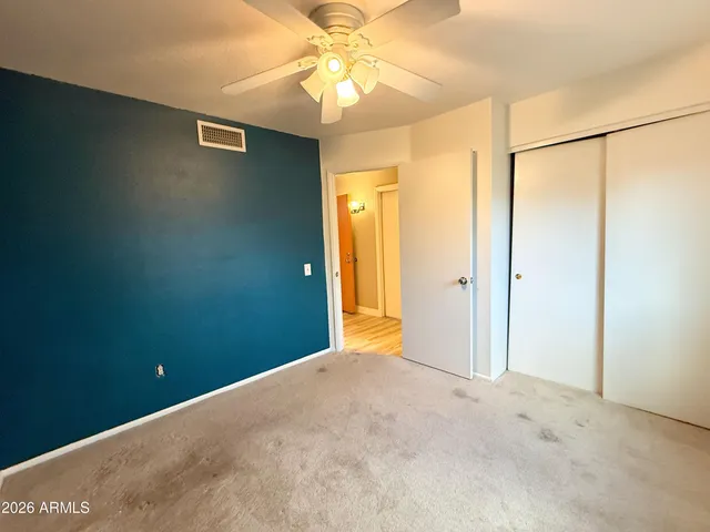 a view of a big room with a chandelier fan and a chandelier fan