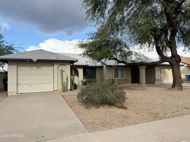 a front view of a house with garage