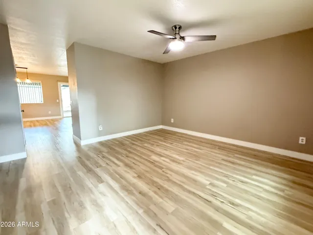 a view of a room with wooden floor and white walls