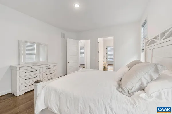 a bedroom with a bed and a dresser