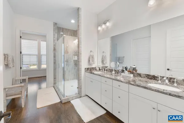 a bathroom with a double vanity sink and mirror