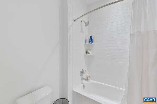 a bathroom with a bathtub and shower
