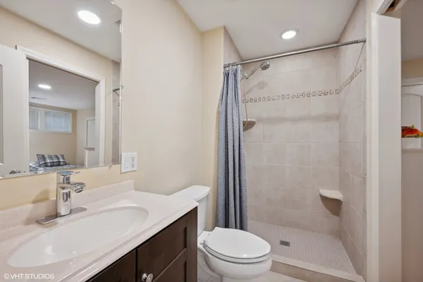 a bathroom with a sink toilet and shower