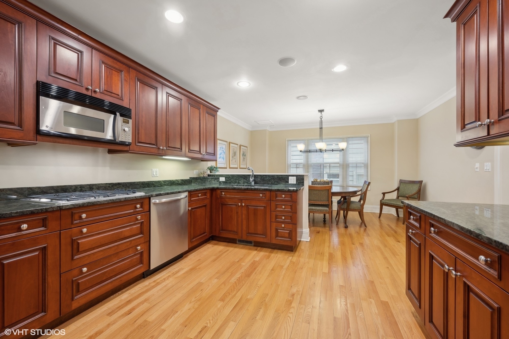 410 Green Bay Road Glencoe, IL 60022 - Photo 5 of 27 a kitchen with stainless steel appliances granite countertop wooden floors stove top oven a sink with granite countertops and cabinets