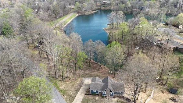 a view of a lake in middle of the forest