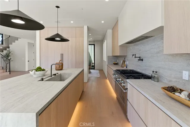 a view of a hallway with wooden floor and windows