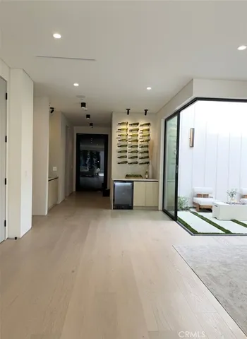 a living room with furniture and a floor to ceiling window