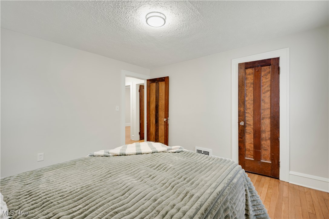 2016 Rossmoor Road Cleveland Heights, OH 44118 - Photo 25 of 46 Bedroom with a textured ceiling and light wood-style flooring