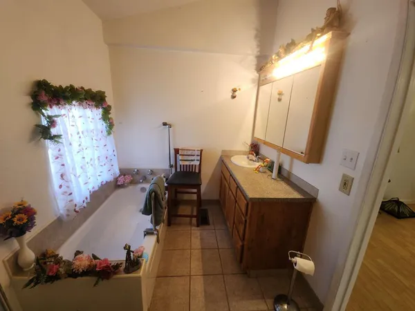 a bathroom with a sink vanity and mirror