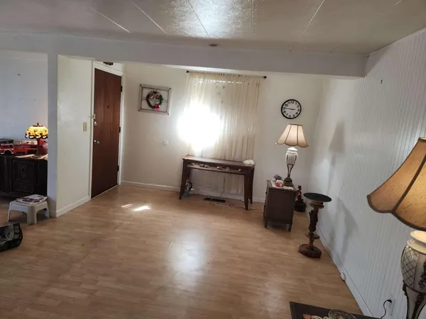 a view of a livingroom with workspace and a window