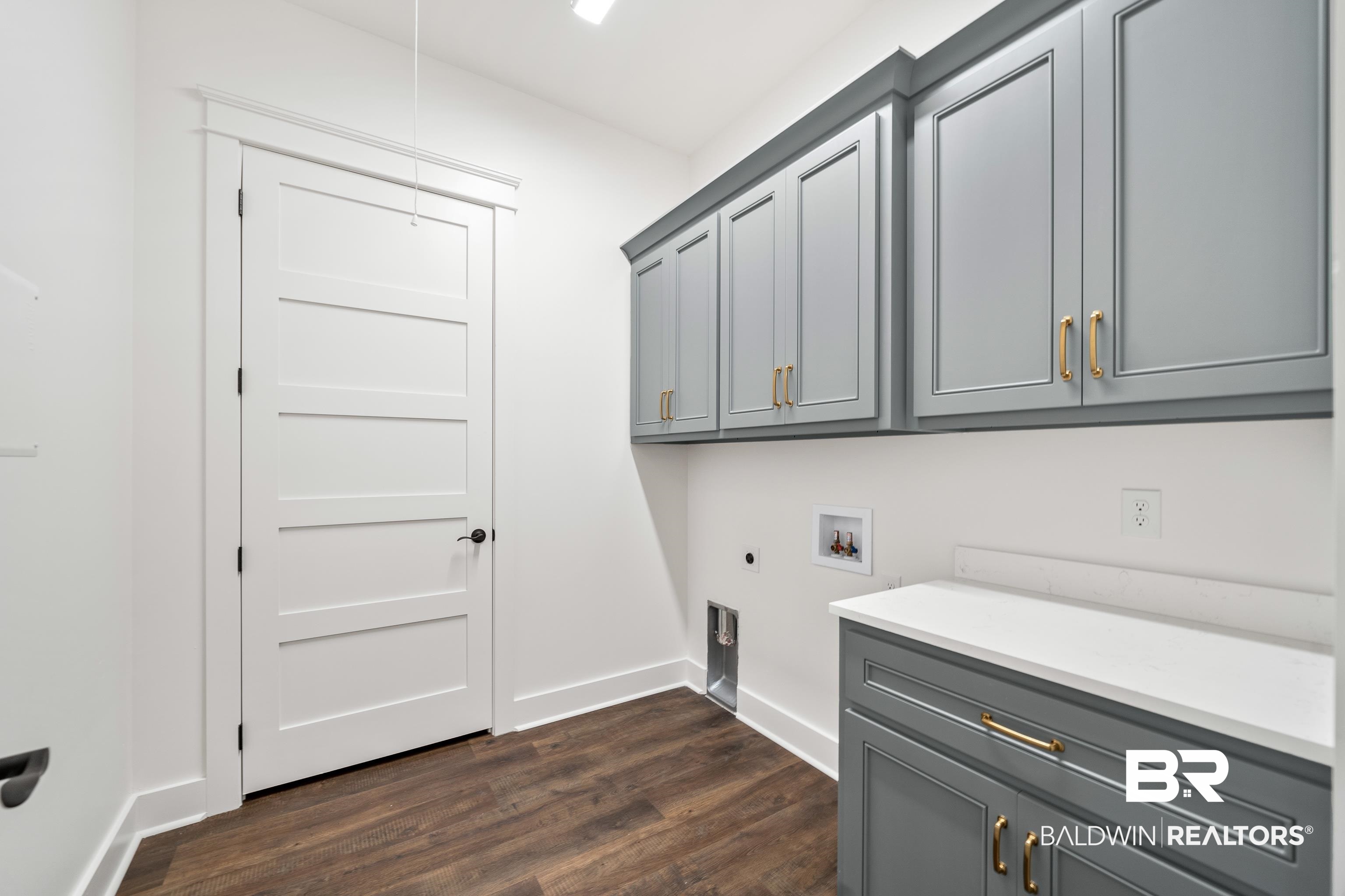 12453 County Road 1 Fairhope, AL 36532 - Photo 17 of 33 Washroom featuring hookup for an electric dryer, dark hardwood / wood-style flooring, cabinets, and washer hookup