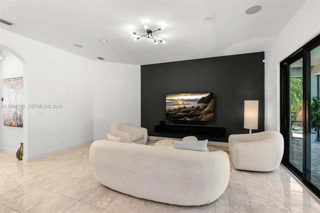 a living room with furniture and a large window