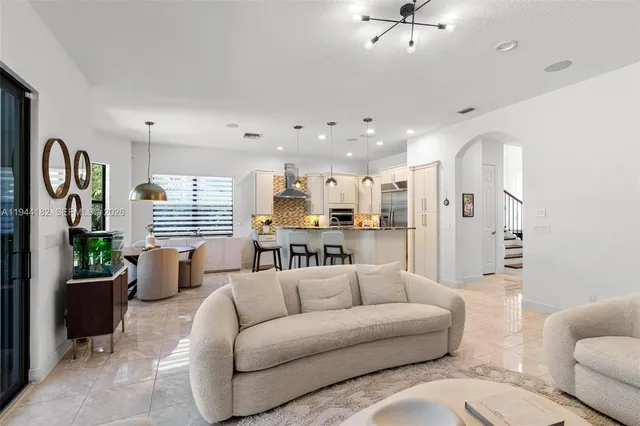 a living room with furniture and a large window