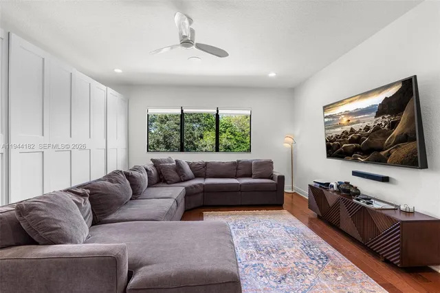 a living room with furniture window and wooden floor