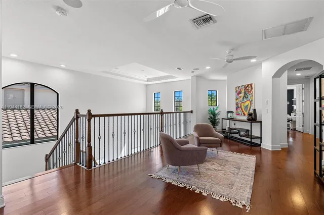 a living room with furniture and a wooden floor