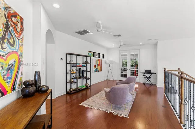 a bedroom with furniture and a wooden floor