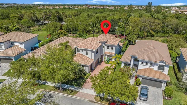 an aerial view of a house with a yard and potted plants