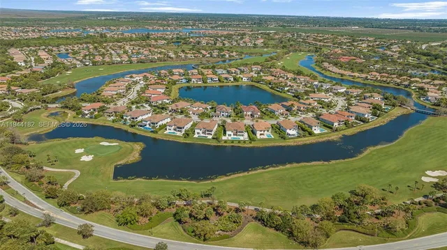 a view of a house with a yard and potted plants