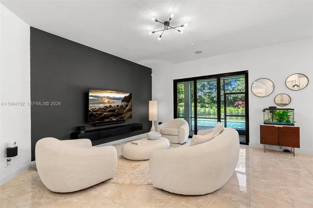 a living room with furniture a large window and a flat screen tv