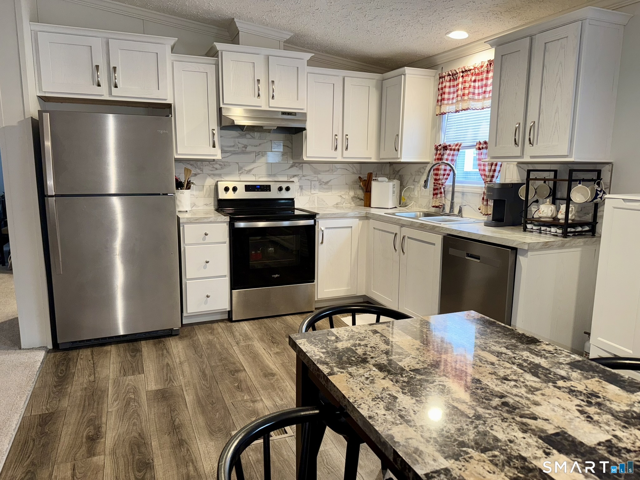 40 Matthews Street Bristol, CT 06010 - Photo 3 of 15 a kitchen with stainless steel appliances granite countertop a refrigerator a stove a sink dishwasher and a refrigerator