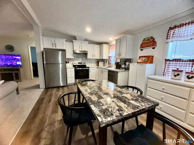 a kitchen with refrigerator and stove