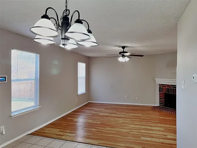 a view of a room with a ceiling fan and window