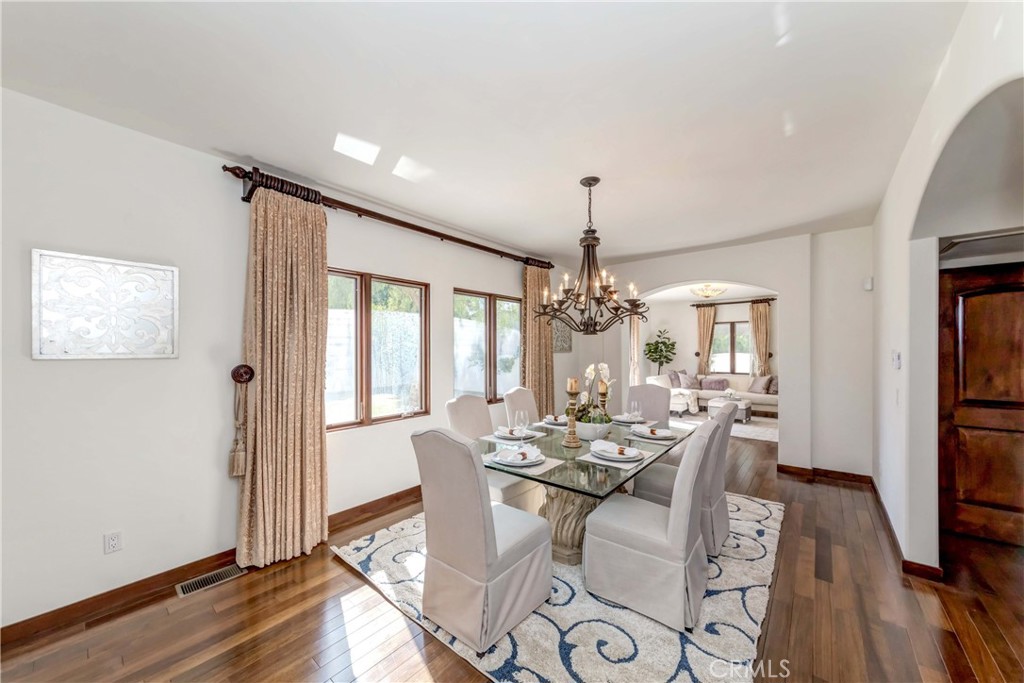 950 Old Mill Road Pasadena, CA 91108 - Photo 13 of 42 a dining room with furniture a chandelier and wooden floor