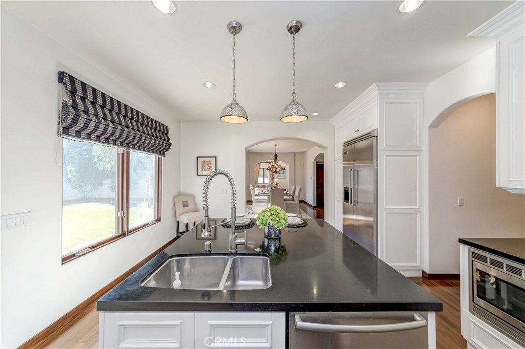 950 Old Mill Road Pasadena, CA 91108 - Photo 18 of 42 a kitchen with a sink a counter space and a view of living room