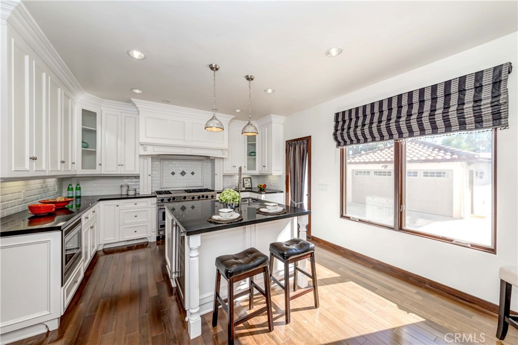 950 Old Mill Road Pasadena, CA 91108 - Photo 19 of 42 a kitchen with a table chairs stove and cabinets