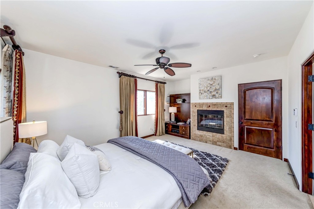 950 Old Mill Road Pasadena, CA 91108 - Photo 25 of 42 a spacious bedroom with a bed and a fireplace