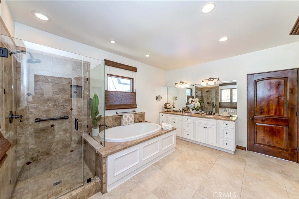 950 Old Mill Road Pasadena, CA 91108 - Photo 26 of 42 a spacious bathroom with a double vanity sink a mirror and a shower