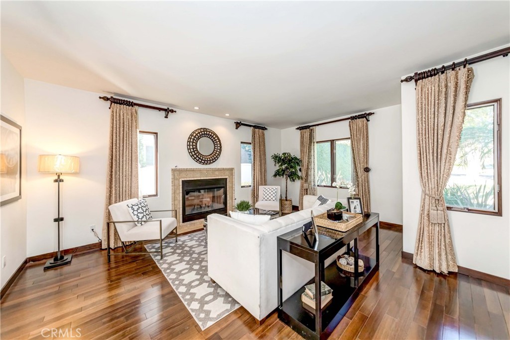 950 Old Mill Road Pasadena, CA 91108 - Photo 7 of 42 a living room with furniture a fireplace and a large window