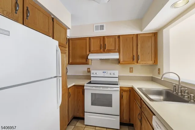 a kitchen with a sink stove and refrigerator