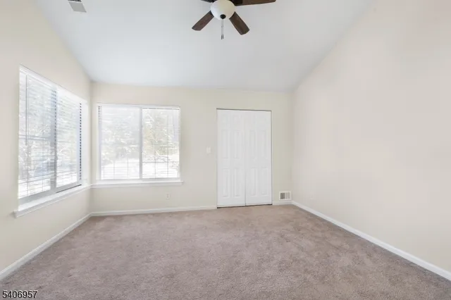 an empty room with a empty space and windows