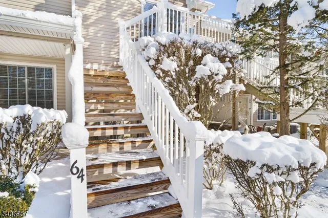 a view of a large building with wooden fence