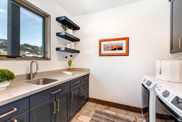 1282 Chimney Rock Road, Unit 344 Heber City, UT 84032 - Photo 23 of 55 Laundry room featuring a stainless steel sink, dark cabinetry with contemporary hardware, light-toned countertop, and tiled flooring