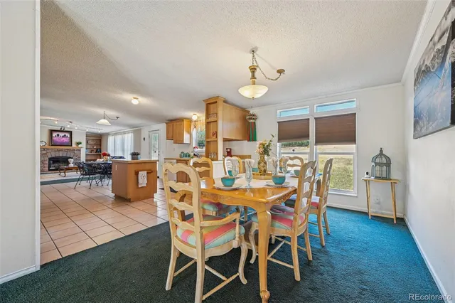 a view of a dining room with furniture and a chandelier