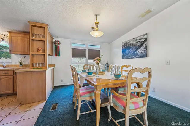 a kitchen with stainless steel appliances kitchen island granite countertop a refrigerator and a stove top oven