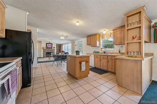 a kitchen with stainless steel appliances granite countertop a refrigerator and a stove