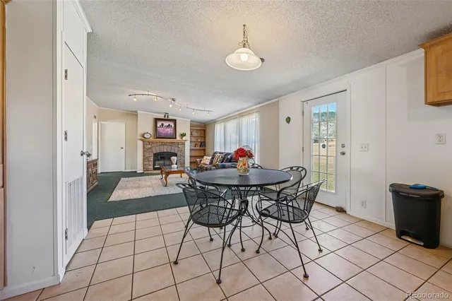 a kitchen with cabinets and chairs
