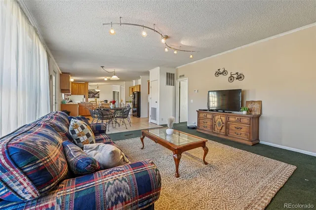 a view of a dining room with furniture and a chandelier