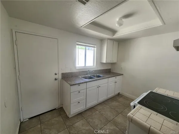 a room with a sink and cabinets