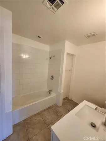 a bathroom with a granite countertop sink a shower and a mirror